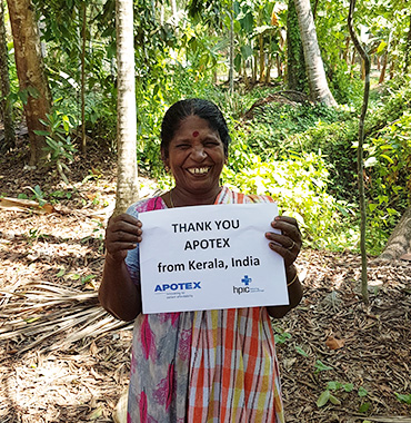 Woman from Kerala holding a sign 